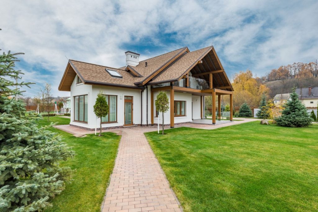 White cottage house with spacious backyard